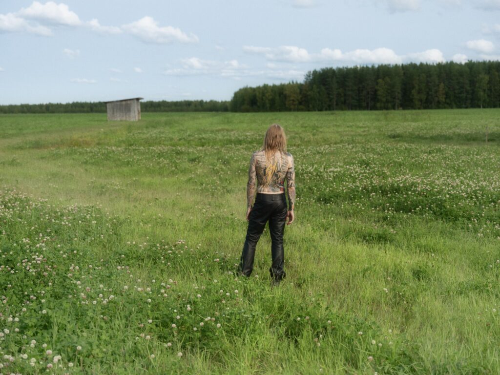 man standing on a green field